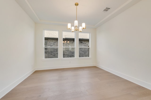 unfurnished dining area with light wood-type flooring and a notable chandelier