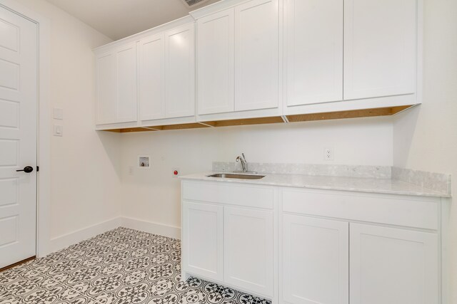 clothes washing area featuring hookup for a washing machine, sink, and cabinets