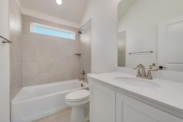 full bathroom featuring tile patterned floors, tiled shower / bath combo, vanity, vaulted ceiling, and toilet