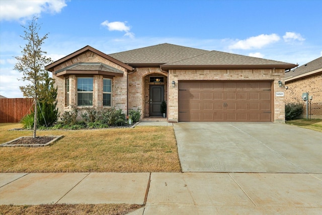 view of front of home with a front yard and a garage