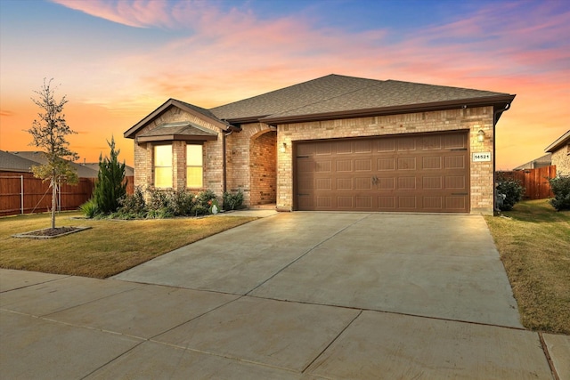 view of front of property featuring a garage and a yard