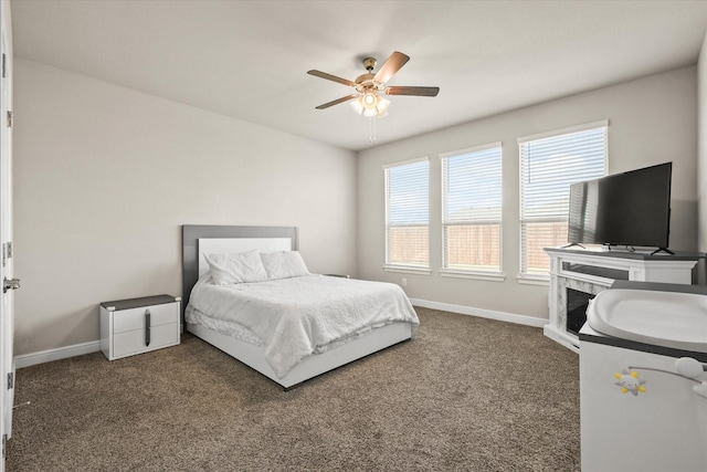 bedroom with dark carpet and ceiling fan