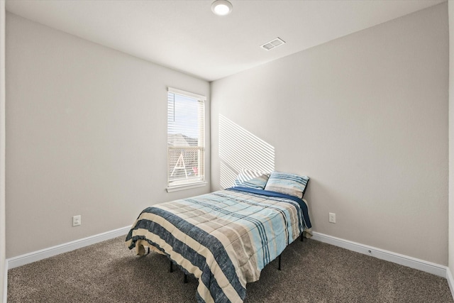 bedroom with dark colored carpet