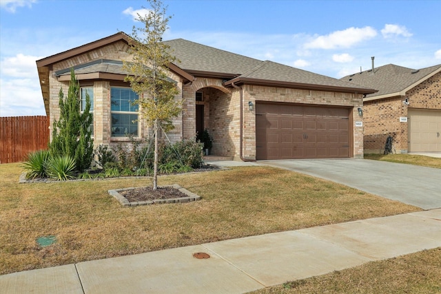 ranch-style home featuring a garage and a front lawn