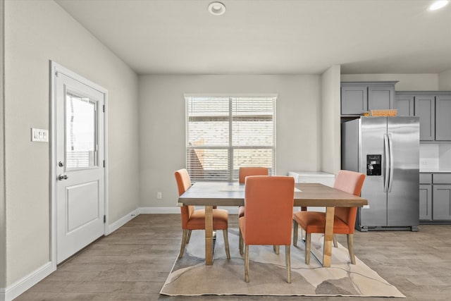 dining space featuring a wealth of natural light and light hardwood / wood-style flooring