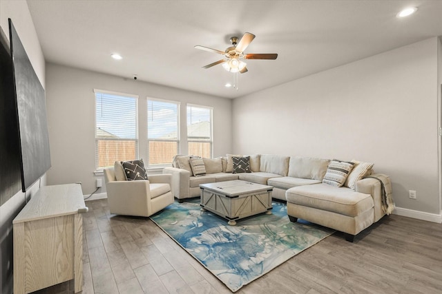 living room with hardwood / wood-style floors and ceiling fan