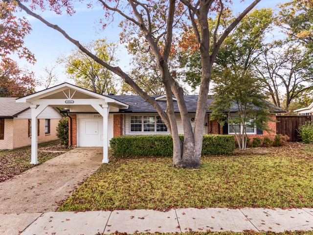 ranch-style home featuring a front yard