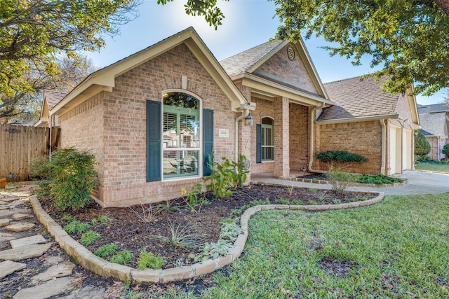 ranch-style home featuring a garage and a front lawn