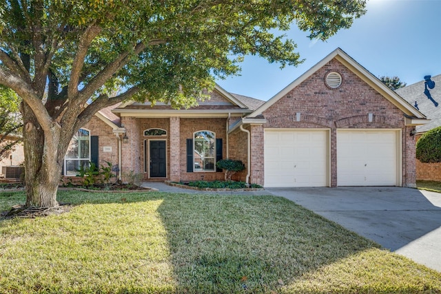 view of front of property with a front yard, central AC, and a garage