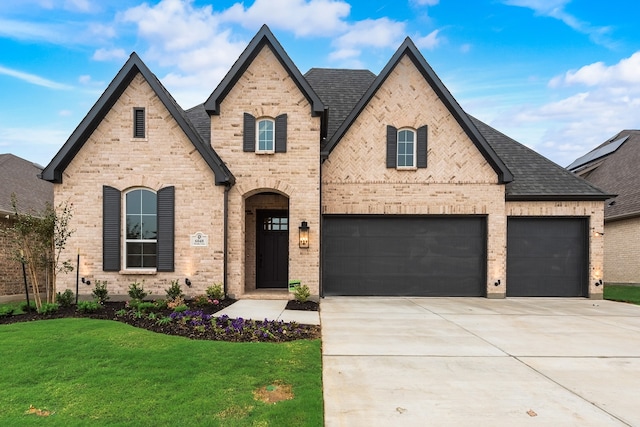 view of front of house with a front yard and a garage