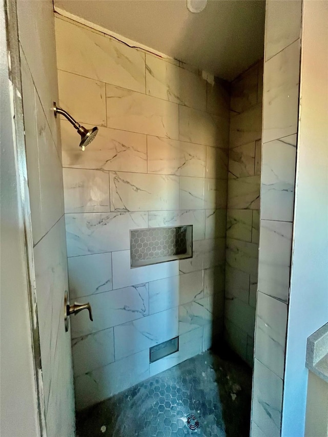 bathroom with a tile shower