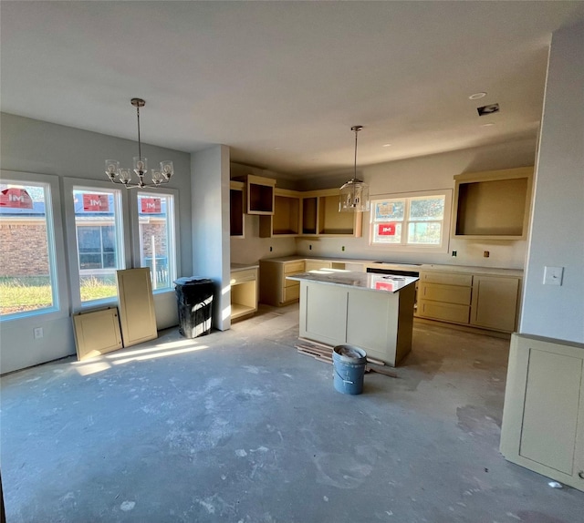 kitchen with decorative light fixtures, a kitchen island, a wealth of natural light, and an inviting chandelier