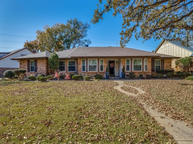 ranch-style home featuring a front yard