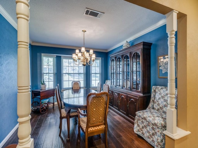 dining room with dark wood-type flooring, ornamental molding, and ornate columns