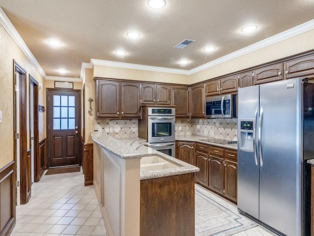 kitchen featuring dark brown cabinetry, sink, light stone counters, crown molding, and stainless steel appliances