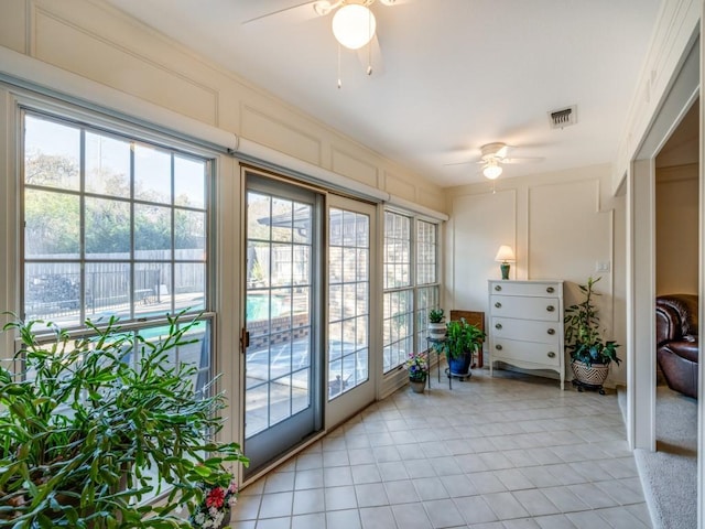 entryway featuring ceiling fan and light tile patterned flooring