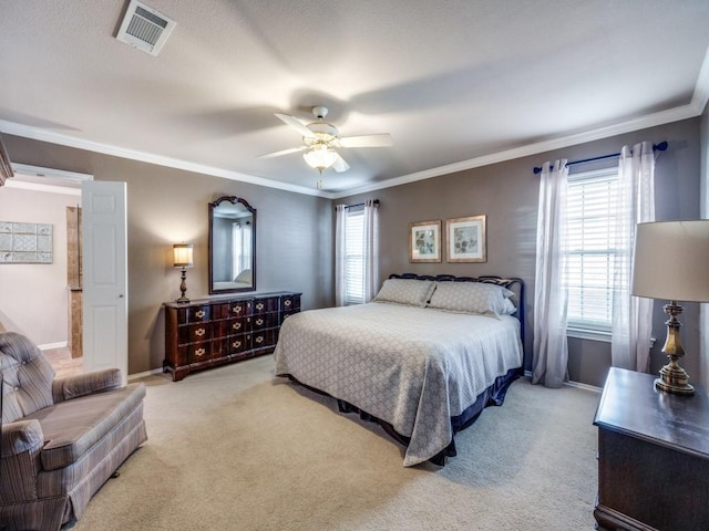 bedroom featuring crown molding, multiple windows, and light carpet