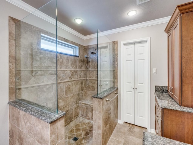 bathroom featuring ornamental molding and a tile shower