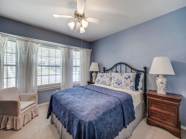 bedroom featuring light carpet and ceiling fan