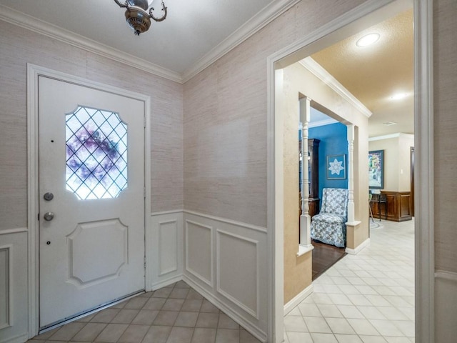 entrance foyer with tile patterned flooring and crown molding