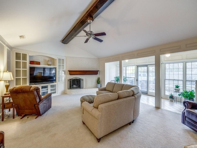 carpeted living room with ceiling fan, vaulted ceiling with beams, and a fireplace