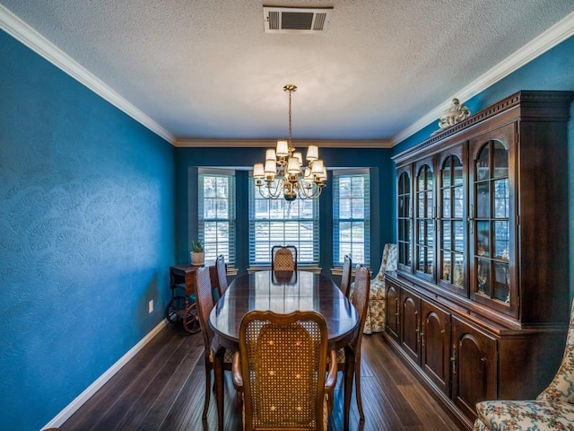 dining room featuring crown molding, dark hardwood / wood-style floors, and a chandelier