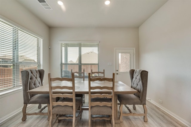 dining space featuring plenty of natural light and light wood-type flooring