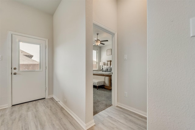 foyer entrance with light hardwood / wood-style flooring and ceiling fan