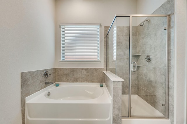 bathroom featuring independent shower and bath