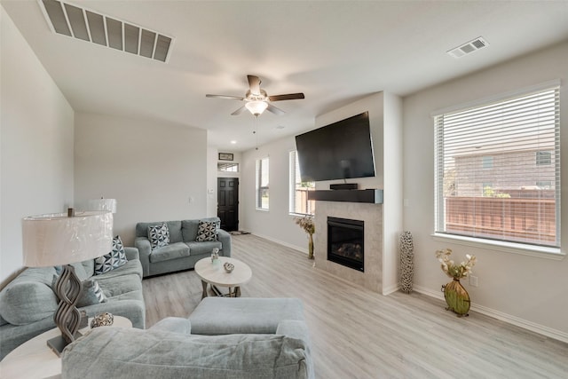 living room featuring ceiling fan and light wood-type flooring