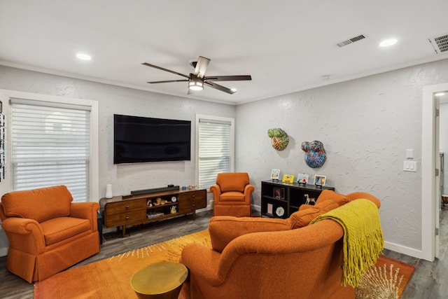 living room with dark hardwood / wood-style floors, plenty of natural light, crown molding, and ceiling fan