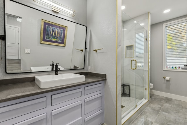 bathroom featuring tile patterned flooring, vanity, toilet, and an enclosed shower