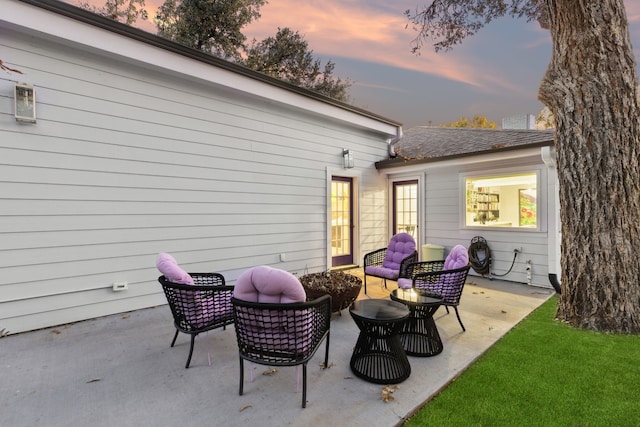 patio terrace at dusk featuring an outdoor hangout area