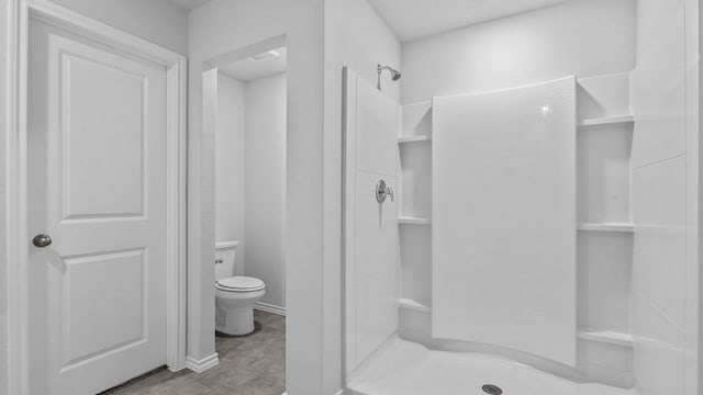 bathroom with a shower and toilet