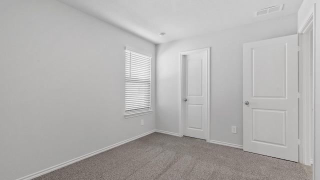 unfurnished bedroom featuring light colored carpet