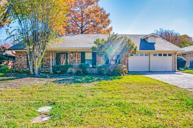 view of front of home with a front lawn and a garage