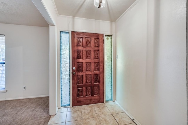 entryway featuring light carpet and ornamental molding