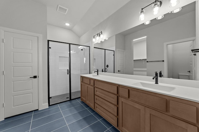 bathroom with double vanity, a stall shower, tile patterned floors, visible vents, and a sink