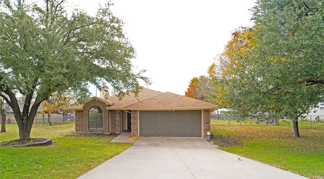 ranch-style home with a garage and a front yard