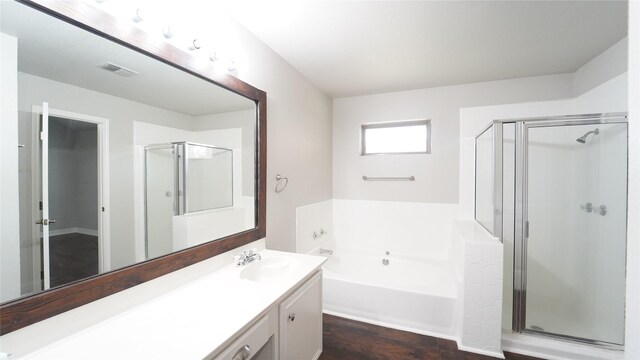 bathroom featuring wood-type flooring, vanity, and independent shower and bath