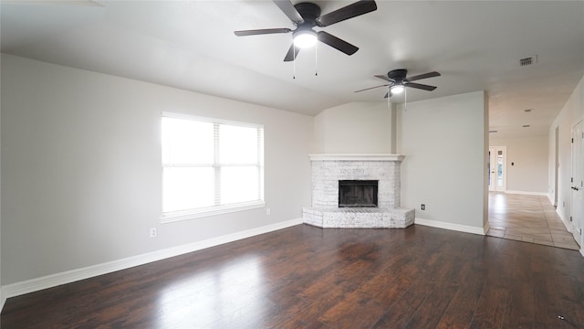 unfurnished living room featuring dark hardwood / wood-style flooring, vaulted ceiling, and ceiling fan