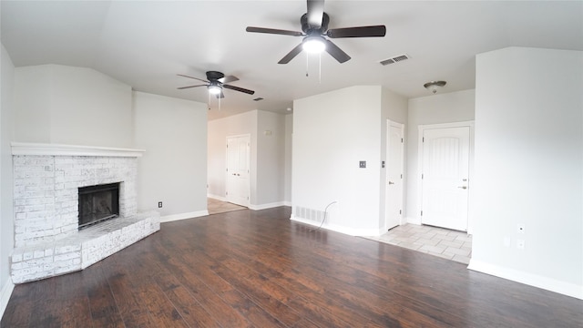 unfurnished living room with a fireplace, ceiling fan, and hardwood / wood-style floors