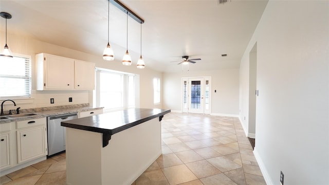 kitchen featuring white cabinetry, sink, a center island, ceiling fan, and stainless steel dishwasher