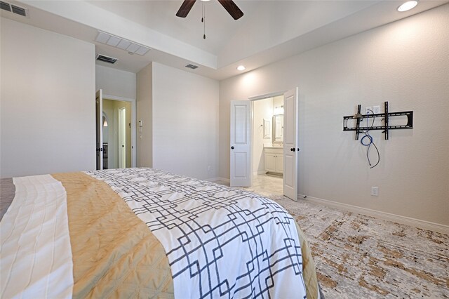 bedroom featuring vaulted ceiling, ensuite bath, and ceiling fan