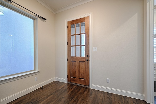 entrance foyer with a healthy amount of sunlight, dark hardwood / wood-style floors, and ornamental molding