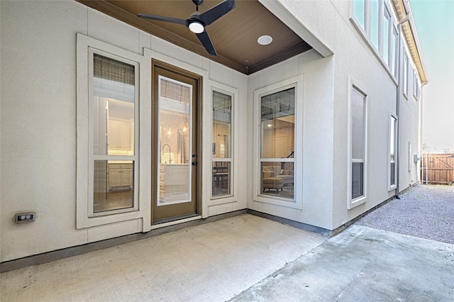 doorway to property featuring a patio and ceiling fan