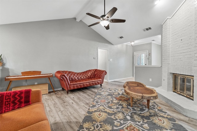 living room with a fireplace, lofted ceiling with beams, hardwood / wood-style flooring, and ceiling fan