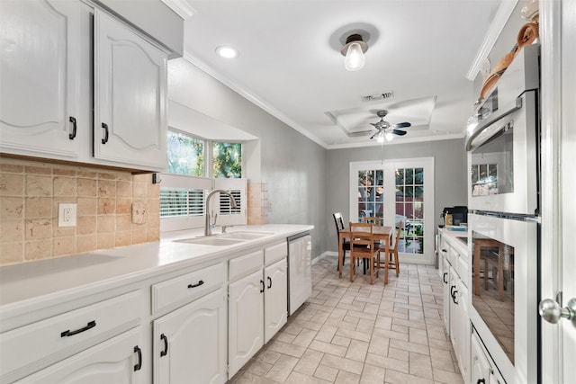 kitchen featuring french doors, tasteful backsplash, stainless steel appliances, sink, and white cabinets