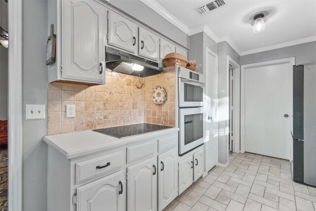 kitchen featuring backsplash, white cabinetry, stainless steel appliances, and ornamental molding