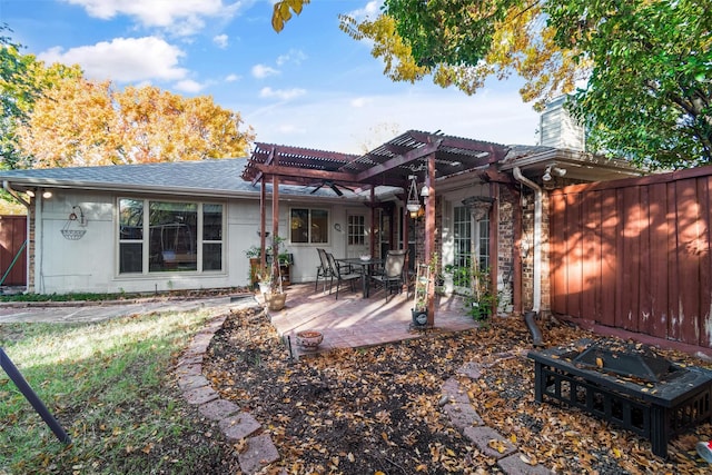 back of property with a patio area and a pergola